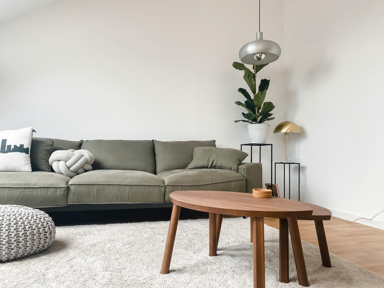Light living room with olive sofa and oak coffee tables