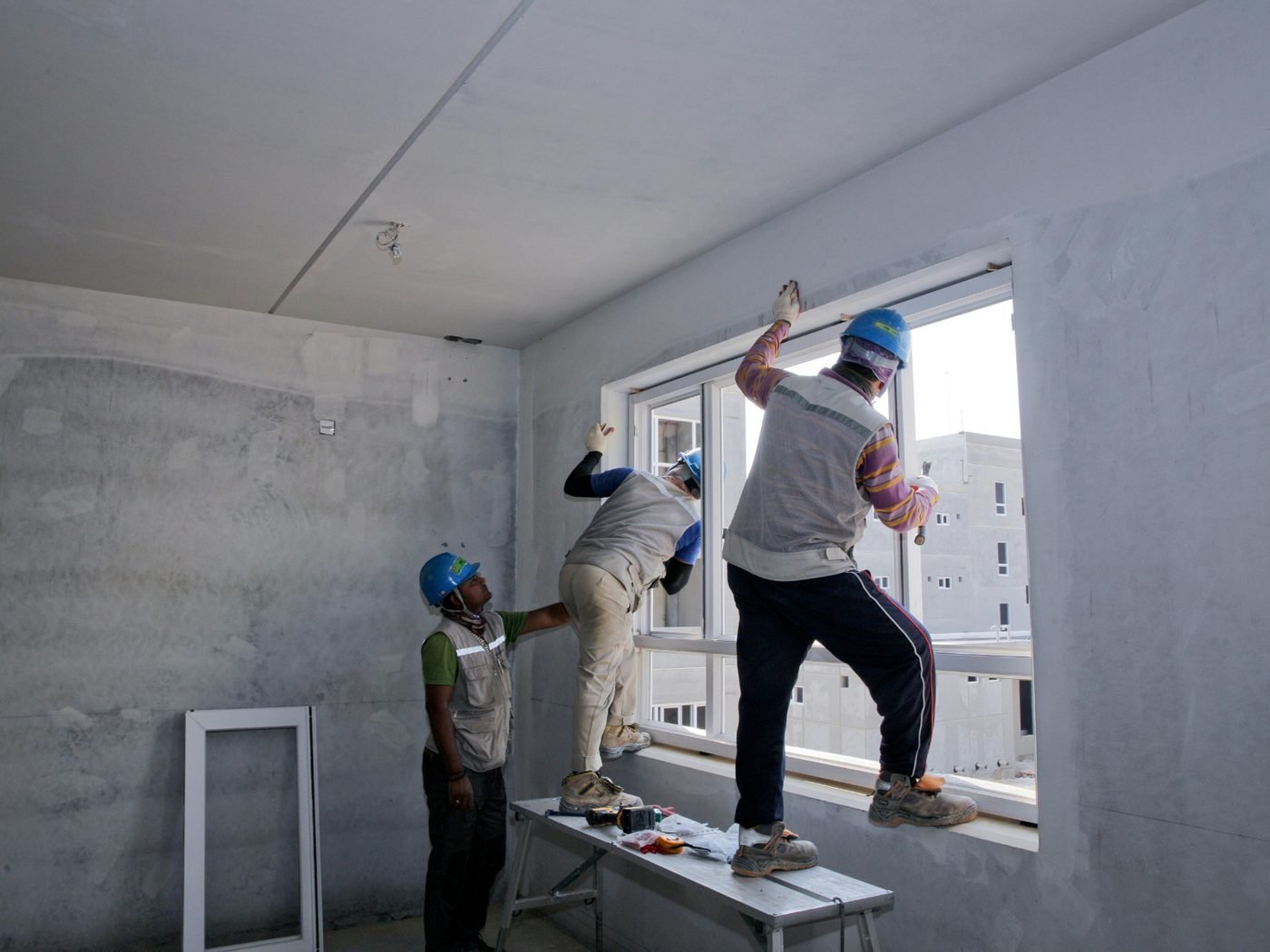 Site team measuring up a window opening