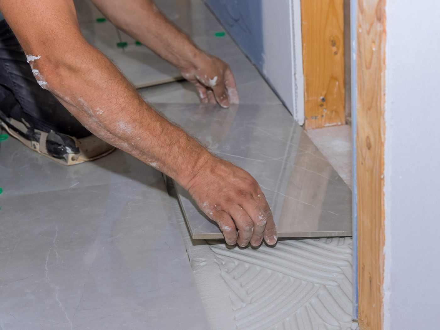 Tiler laying large-format tiles